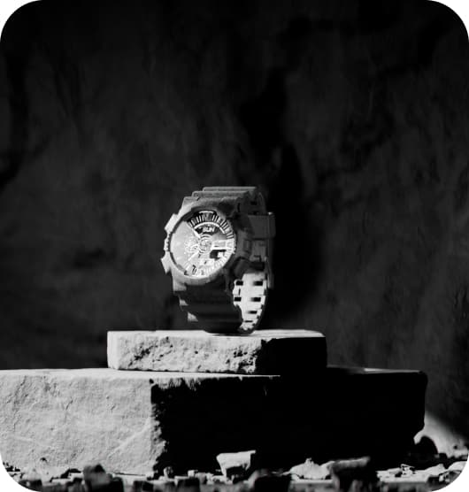 black wristwatch on brick